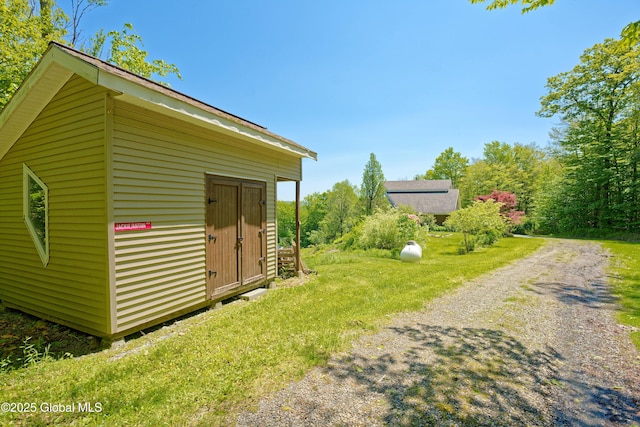 107 Wilderness Way, Stephentown, NY 12169 - view of property exterior featuring a storage unit and a lawn