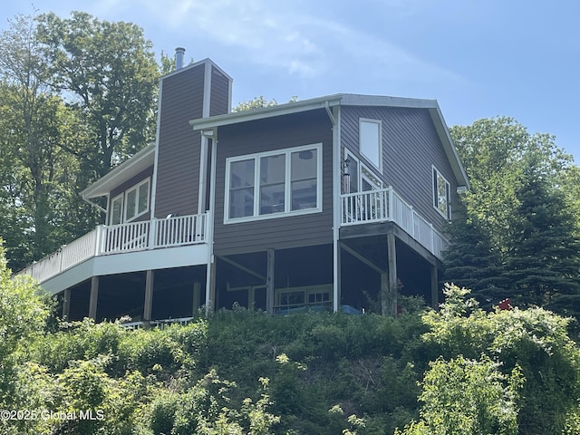 107 Wilderness Way, Stephentown, NY 12169 - rear view of property featuring a chimney and a wooden deck