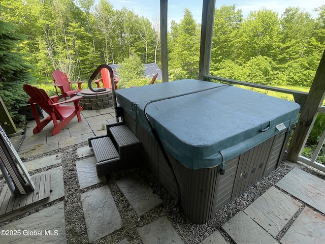 107 Wilderness Way, Stephentown, NY 12169 - view of patio with a hot tub, an outdoor fire pit, and a forest view