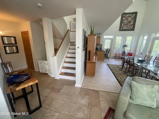 107 Wilderness Way, Stephentown, NY 12169 - living room with stairway, a high ceiling, and healthy amount of natural light