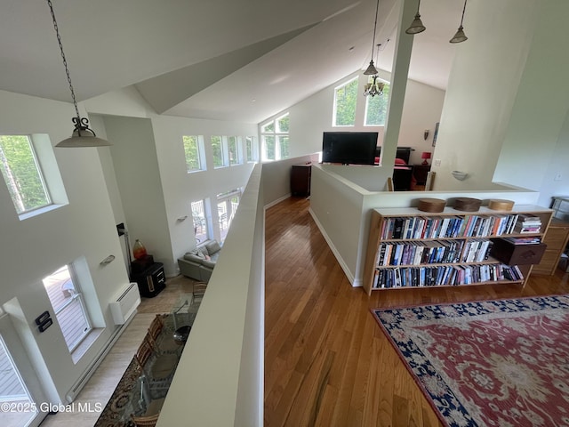 107 Wilderness Way, Stephentown, NY 12169 - hall with light wood-type flooring, a baseboard radiator, and high vaulted ceiling