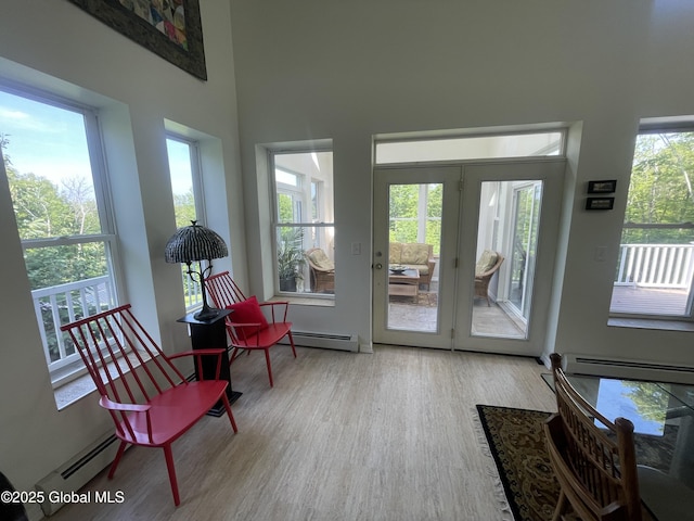 107 Wilderness Way, Stephentown, NY 12169 - sitting room featuring baseboard heating, wood finished floors, and a high ceiling