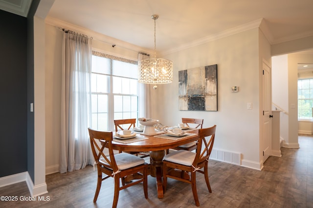 dining room with wood finished floors, a chandelier, ornamental molding, baseboards, and visible vents