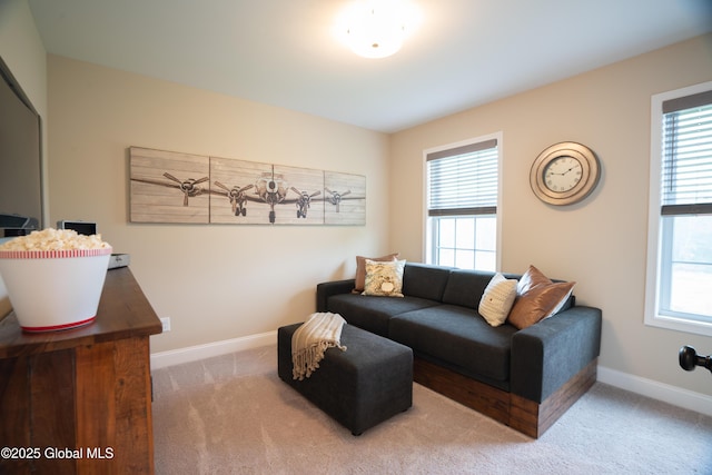 living area with baseboards, carpet, and plenty of natural light