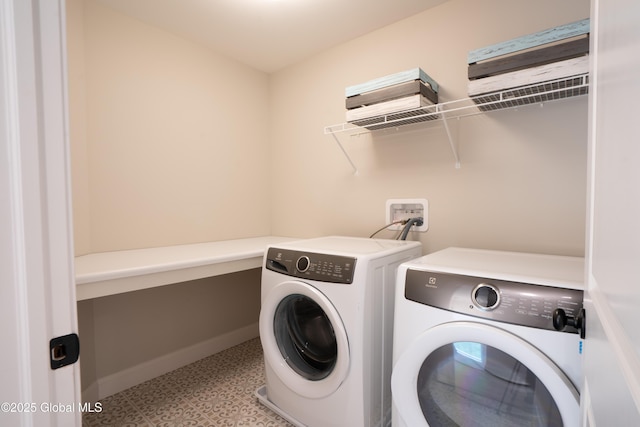 washroom featuring tile patterned floors, baseboards, laundry area, and washer and clothes dryer