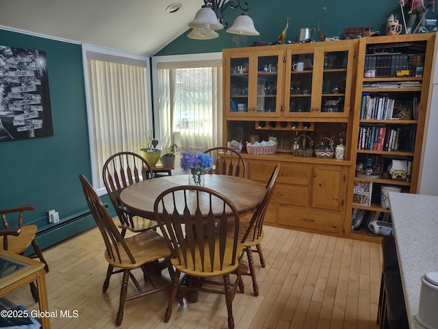 1486 County Highway 112, Caroga, NY 12032 - dining area featuring a notable chandelier, lofted ceiling, and light wood finished floors