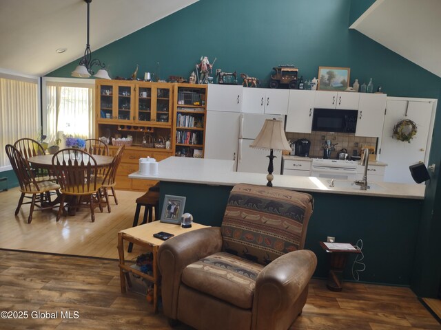 1486 County Highway 112, Caroga, NY 12032 - interior space featuring vaulted ceiling, white appliances, wood finished floors, and white cabinetry