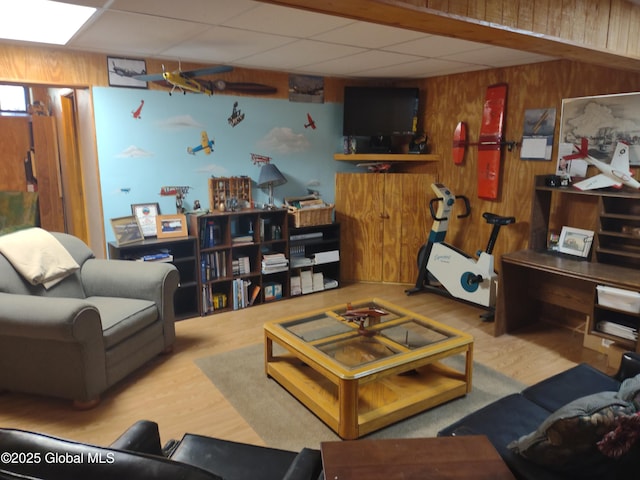 1486 County Highway 112, Caroga, NY 12032 - living area featuring a drop ceiling, wood walls, and wood finished floors