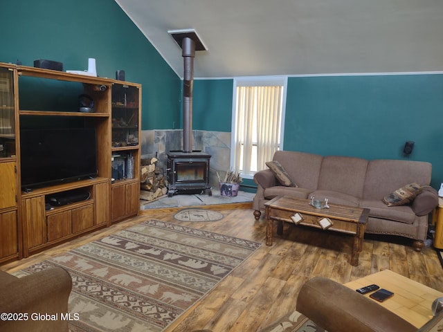 1486 County Highway 112, Caroga, NY 12032 - living area featuring light wood-style floors, a wood stove, and lofted ceiling