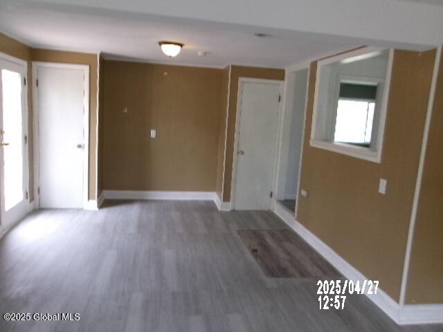 spare room with wood finished floors and baseboards