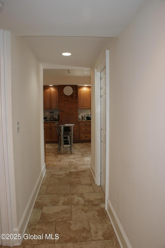hallway featuring baseboards