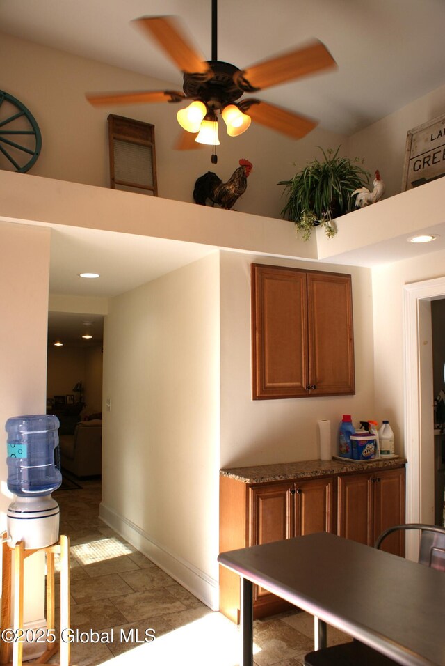 interior space featuring a towering ceiling and a ceiling fan