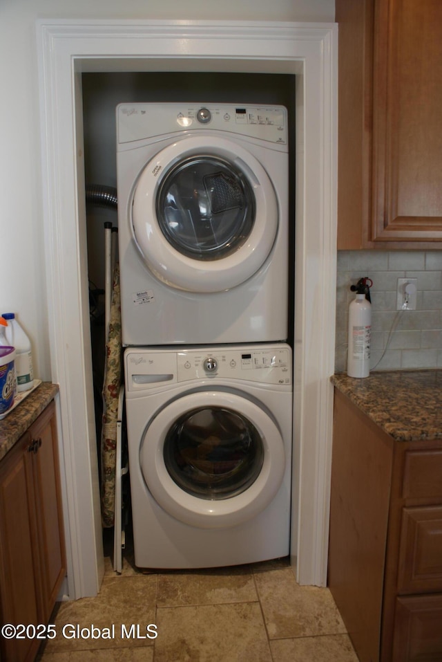 washroom with stacked washer / dryer and laundry area