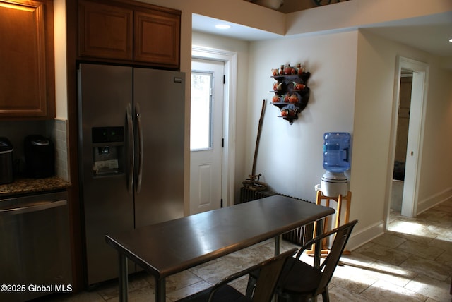 kitchen with recessed lighting, brown cabinets, appliances with stainless steel finishes, and baseboards