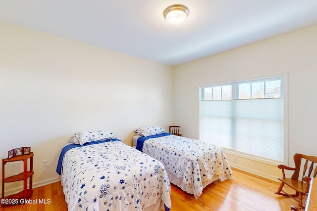 bedroom with baseboards and light wood-style flooring