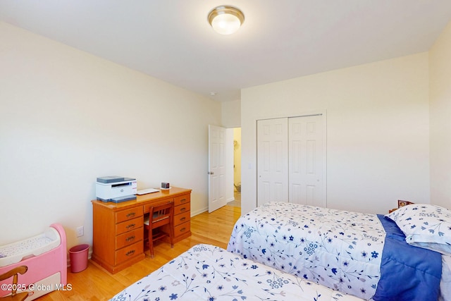 bedroom with light wood-type flooring and a closet