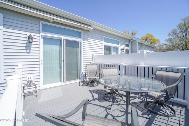 wooden deck with outdoor dining space