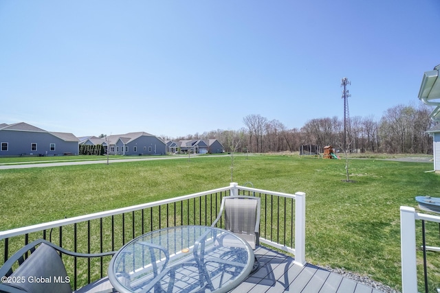 deck featuring a lawn and a residential view