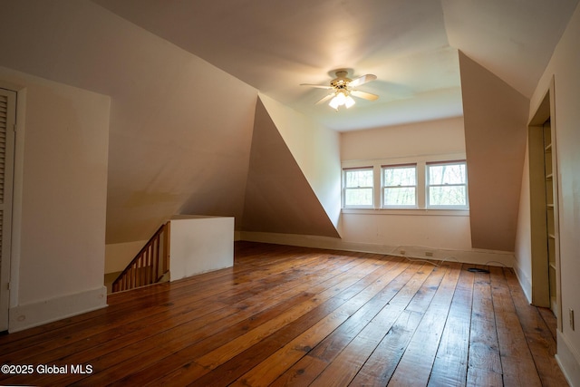 bonus room with ceiling fan, hardwood / wood-style flooring, and baseboards