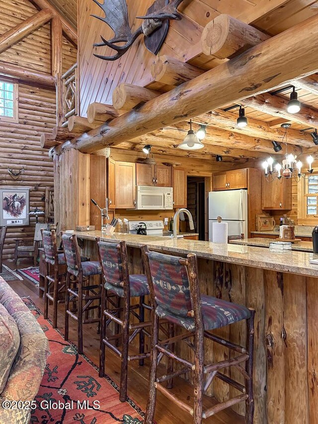 25 Birch Dr, Bolton, NY 12824 - kitchen featuring white appliances, rustic walls, wood ceiling, wood-type flooring, and beamed ceiling