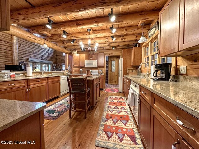 25 Birch Dr, Bolton, NY 12824 - kitchen featuring white appliances, wood ceiling, light wood finished floors, brown cabinetry, and log walls