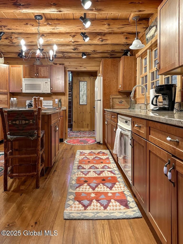 25 Birch Dr, Bolton, NY 12824 - kitchen featuring white appliances, light wood-style floors, brown cabinetry, and beam ceiling