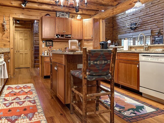 25 Birch Dr, Bolton, NY 12824 - kitchen with dishwasher, rustic walls, light wood-type flooring, a chandelier, and brown cabinets