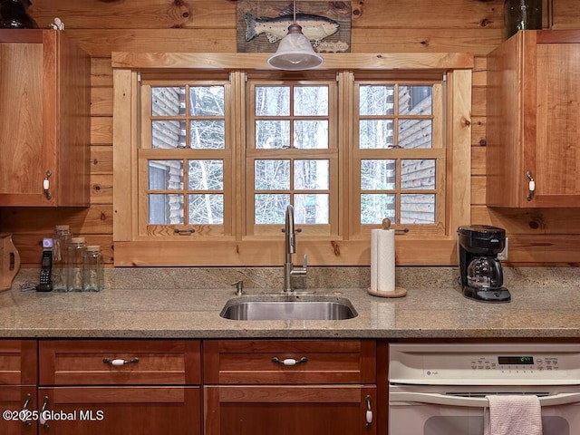 25 Birch Dr, Bolton, NY 12824 - kitchen featuring a sink, brown cabinetry, light stone counters, and plenty of natural light