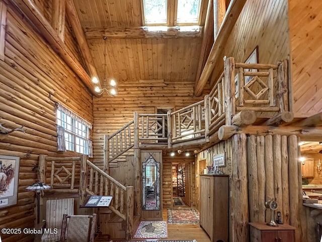25 Birch Dr, Bolton, NY 12824 - stairway featuring a towering ceiling, rustic walls, wood finished floors, wood ceiling, and beam ceiling
