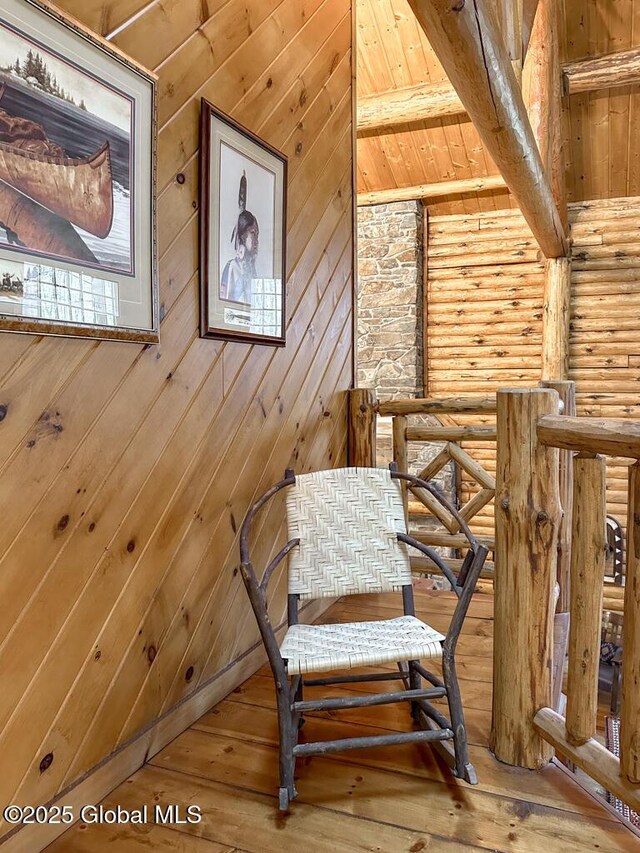 25 Birch Dr, Bolton, NY 12824 - living area featuring hardwood / wood-style flooring, rustic walls, and an upstairs landing