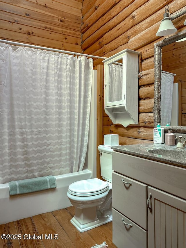 25 Birch Dr, Bolton, NY 12824 - full bath featuring log walls, toilet, shower / bath combo, vanity, and wood finished floors