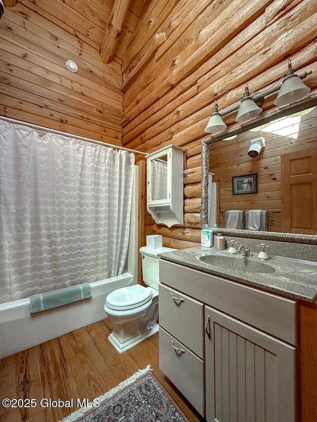 25 Birch Dr, Bolton, NY 12824 - bathroom with rustic walls, wood finished floors, toilet, beam ceiling, and shower / bath combination with curtain