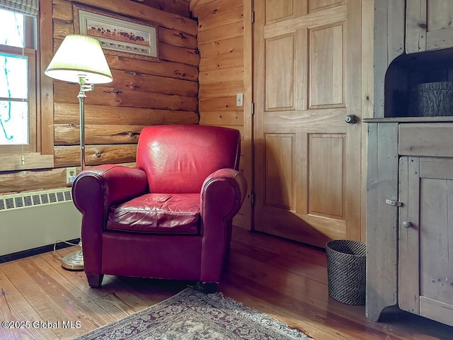 25 Birch Dr, Bolton, NY 12824 - sitting room featuring radiator, wood-type flooring, and rustic walls