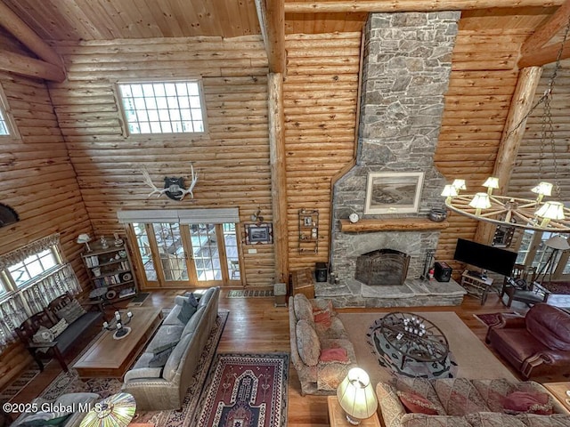 25 Birch Dr, Bolton, NY 12824 - living area featuring a fireplace, wood finished floors, rustic walls, healthy amount of natural light, and wood ceiling