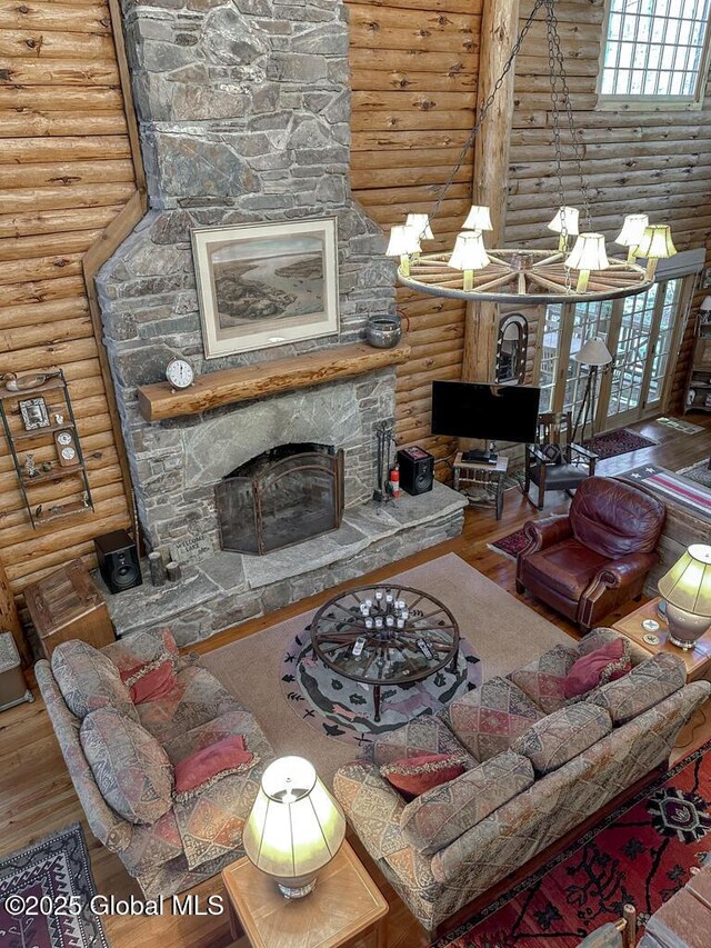 25 Birch Dr, Bolton, NY 12824 - living area with log walls, a stone fireplace, wood finished floors, a high ceiling, and healthy amount of natural light