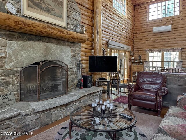 25 Birch Dr, Bolton, NY 12824 - living room with a towering ceiling, rustic walls, plenty of natural light, a fireplace, and wood finished floors