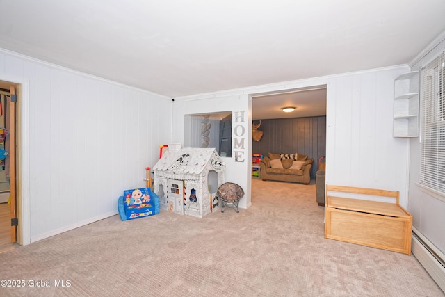 rec room featuring carpet floors, ornamental molding, and a baseboard radiator