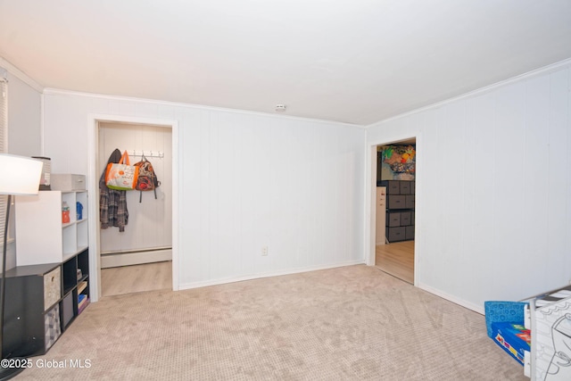 interior space featuring crown molding, carpet floors, a baseboard radiator, and baseboards