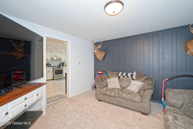living room featuring crown molding and light carpet