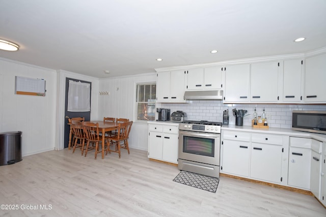 kitchen featuring backsplash, appliances with stainless steel finishes, light countertops, under cabinet range hood, and white cabinetry