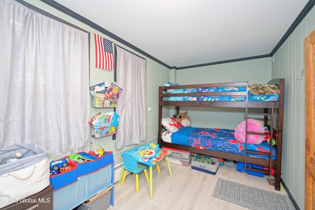 bedroom featuring crown molding and wood finished floors