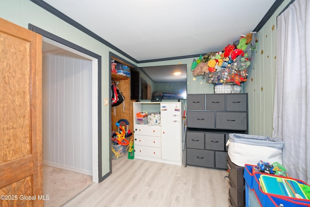 bedroom with crown molding, baseboards, and wood finished floors
