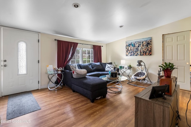 living room with wood finished floors and vaulted ceiling