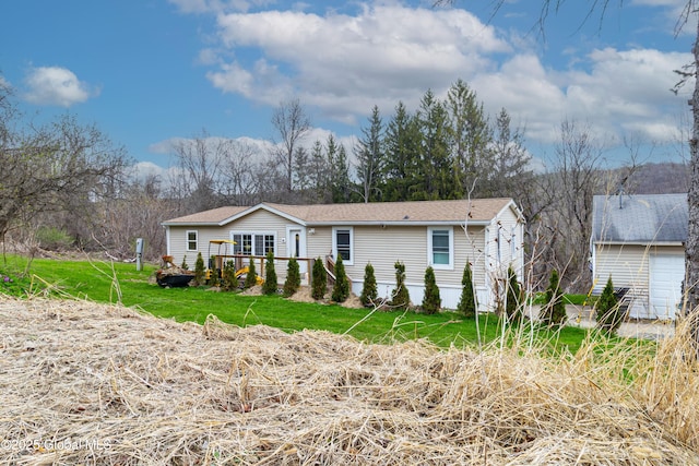 ranch-style home featuring a front lawn and roof with shingles