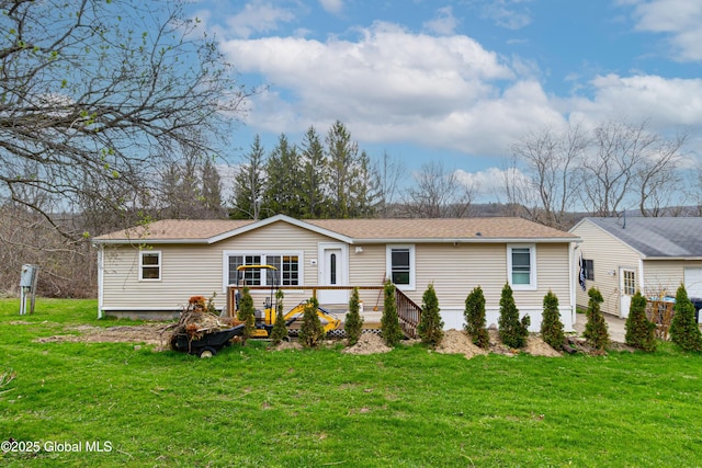 view of front of house with a shingled roof and a front lawn