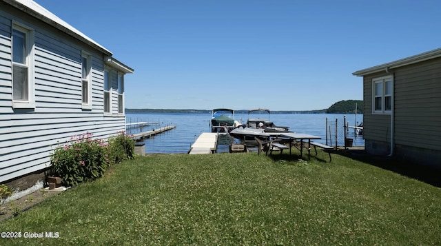 exterior space with a water view and a dock