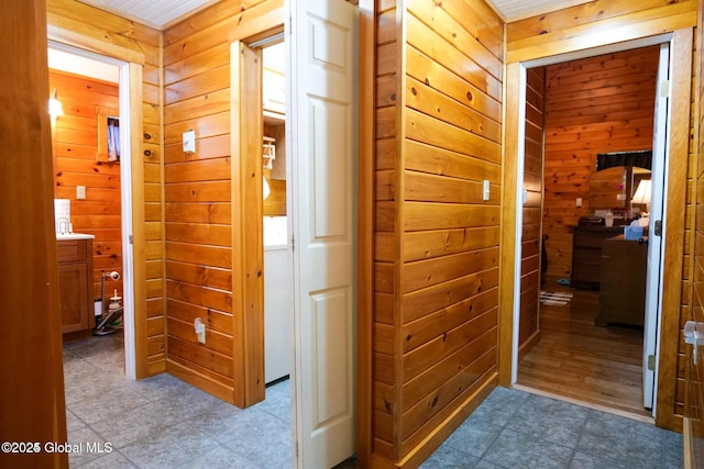 hallway featuring wooden walls