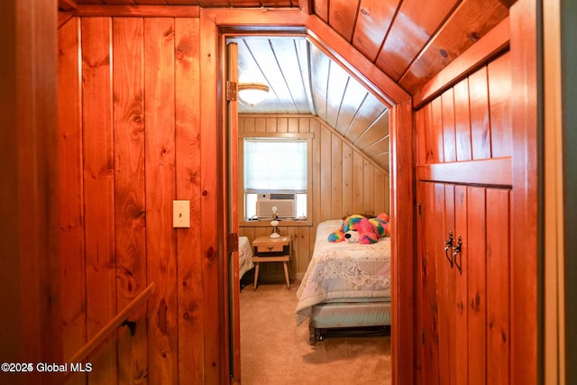 bedroom featuring wooden walls, cooling unit, carpet flooring, and lofted ceiling