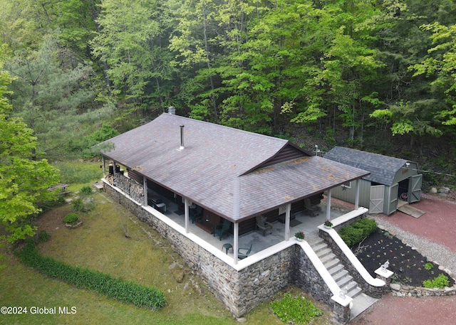 aerial view featuring a wooded view
