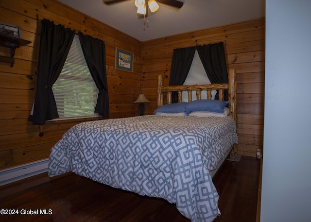 bedroom with wood walls, wood finished floors, and ceiling fan
